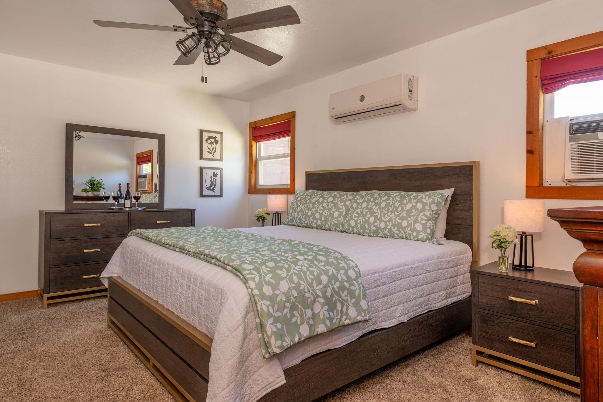 Master bedroom with king bed with chest of drawers and nightstand