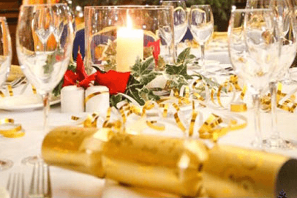 Gold theme table setting with champagne glasses and candles